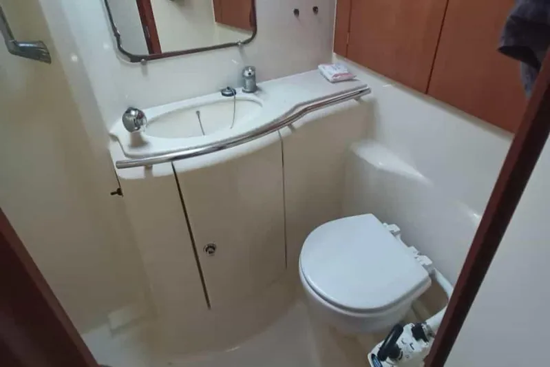  Yacht Photos Pics Bathroom interior of 2004 Dufour 44 Performance yacht, featuring sink and toilet.