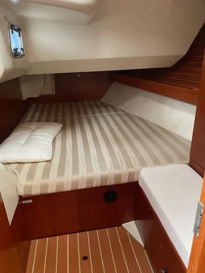  Yacht Photos Pics Cabin interior of 2004 Dufour 44 Performance yacht with striped bedding.