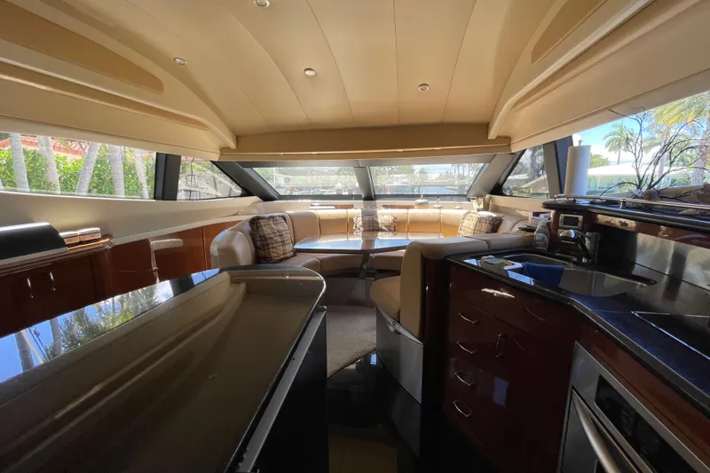  Yacht Photos Pics Luxurious interior of a 2006 Marquis 59 yacht with modern furnishings and panoramic windows.