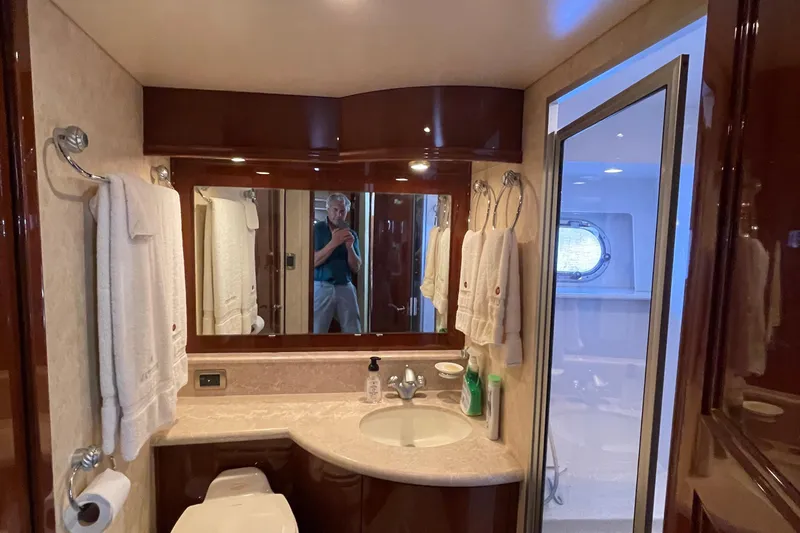  Yacht Photos Pics Luxurious bathroom interior of a 2006 Marquis 59 yacht with elegant fixtures and towels.