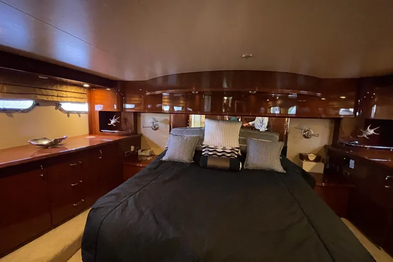  Yacht Photos Pics Luxurious 2006 Marquis 59 yacht bedroom with elegant wood finish and plush bedding.