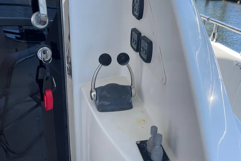  Yacht Photos Pics Control panel of a 2006 Marquis 59 yacht with throttle levers and switches.