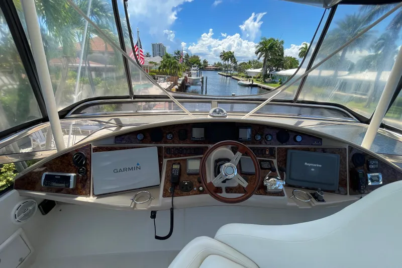  Yacht Photos Pics Helm of 2006 Marquis 59 yacht with Garmin and Raymarine navigation systems, overlooking a scenic canal.