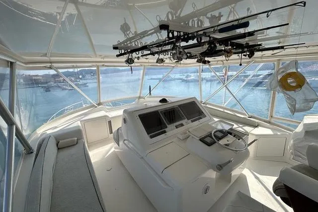  Yacht Photos Pics 2008 Viking Boats 60 Convertible helm with fishing rods, overlooking marina.