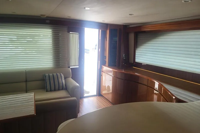  Yacht Photos Pics Luxurious interior of 2008 Viking Boats 60 Convertible with elegant wood finishes and comfortable seating.