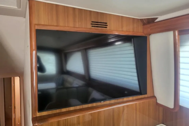  Yacht Photos Pics Flat-screen TV in 2008 Viking Boats 60 Convertible interior with wood paneling.