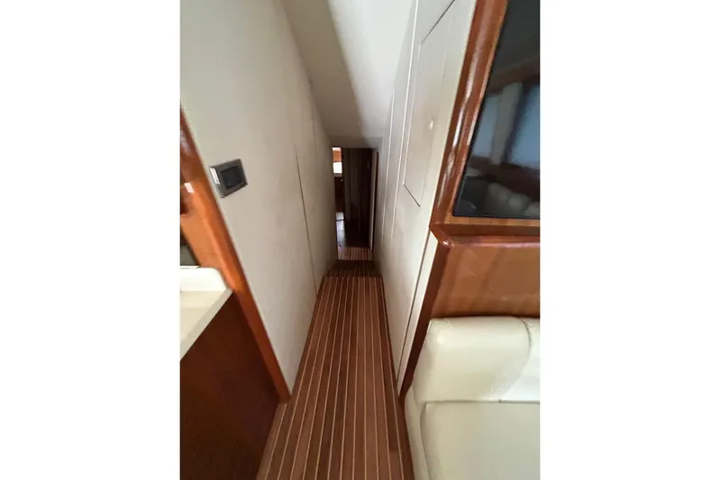  Yacht Photos Pics Interior hallway of 2008 Viking Boats 60 Convertible, featuring wood paneling and modern design.