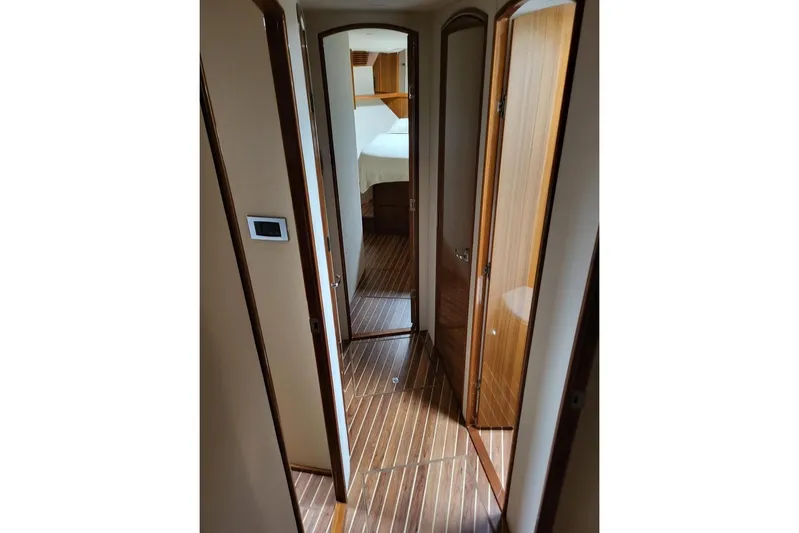  Yacht Photos Pics Interior hallway of 2008 Viking Boats 60 Convertible, featuring wooden flooring and doors.