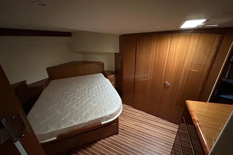  Yacht Photos Pics 2008 Viking Boats 60 Convertible cabin with wooden interior and bed.