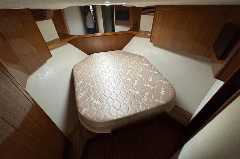  Yacht Photos Pics 2008 Viking Boats 60 Convertible cabin with a cozy bed and wooden interior.