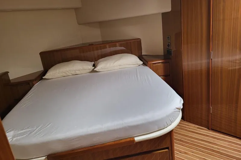  Yacht Photos Pics Luxurious bedroom interior of 2008 Viking Boats 60 Convertible yacht with wooden furnishings.