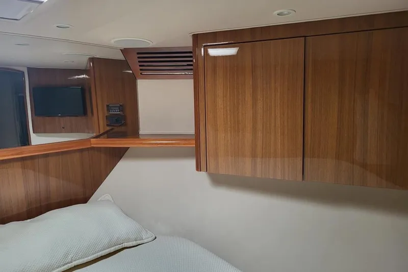  Yacht Photos Pics Luxurious cabin interior of 2008 Viking Boats 60 Convertible with wood paneling and TV.