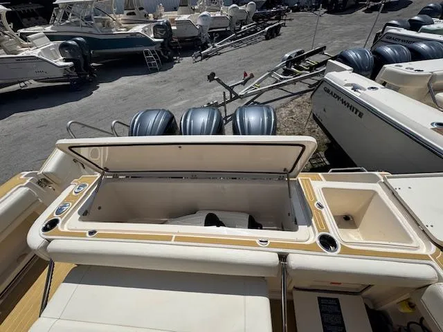  Yacht Photos Pics 2022 Grady-White Express 370 boat with open storage compartment and multiple outboard engines.