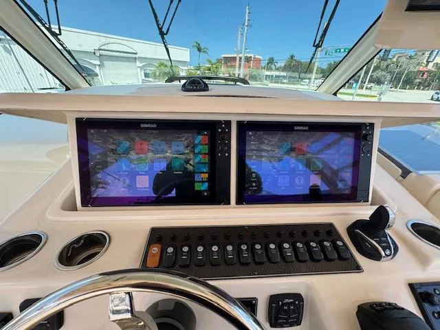  Yacht Photos Pics 2022 Grady-White Express 370 helm with dual navigation screens and control panel.