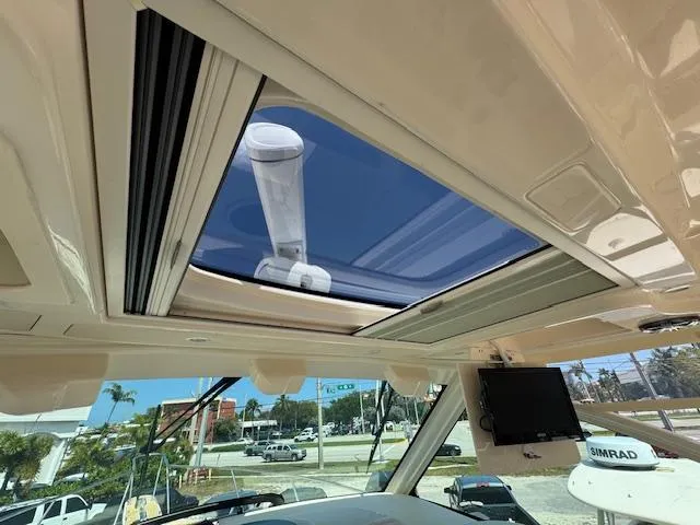 Yacht Photos Pics Interior view of 2022 Grady-White Express 370 boat with sunroof and navigation equipment.