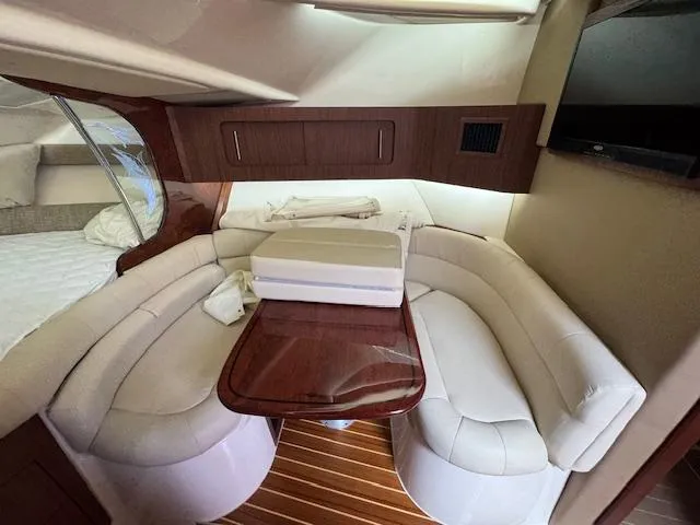  Yacht Photos Pics 2022 Grady-White Express 370 cabin with elegant seating and wooden table.