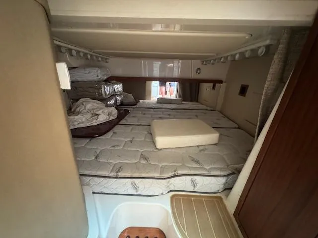  Yacht Photos Pics 2022 Grady-White Express 370 cabin interior with bedding and storage space.