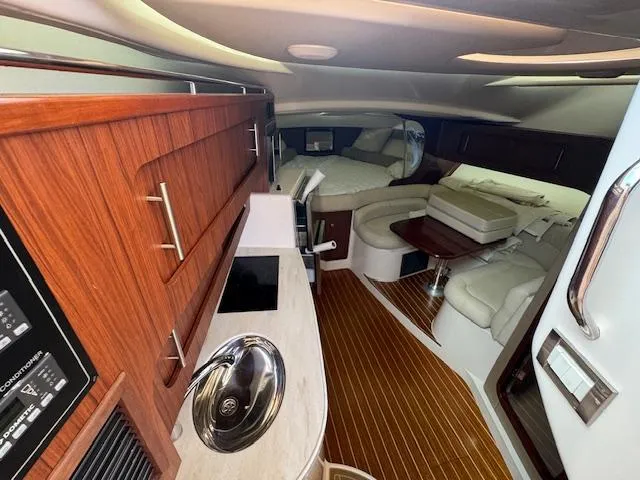  Yacht Photos Pics 2022 Grady-White Express 370 interior with wood cabinetry and seating area.