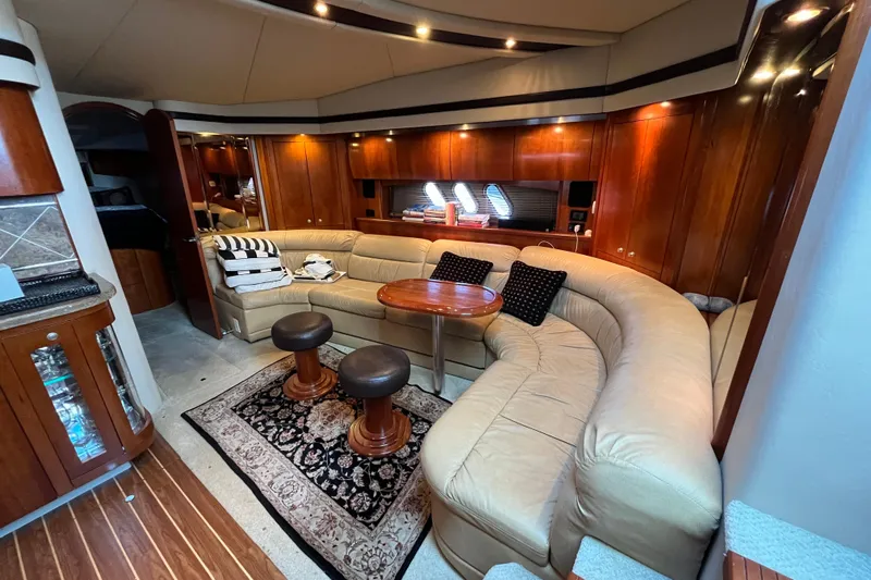 Dolcinea Yacht Photos Pics Luxurious interior of 2010 Cruisers Yachts 520 Sports Coupe with leather seating and wooden accents.