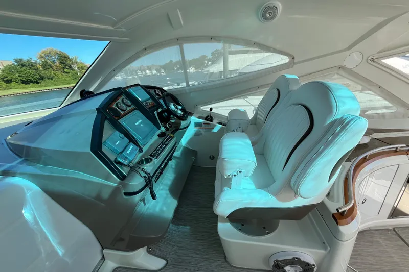 Dolcinea Yacht Photos Pics Interior of 2010 Cruisers Yachts 520 Sports Coupe with modern helm and plush seating.