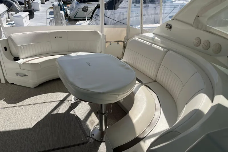 Dolcinea Yacht Photos Pics Luxurious seating area on a 2010 Cruisers Yachts 520 Sports Coupe, featuring elegant white upholstery.