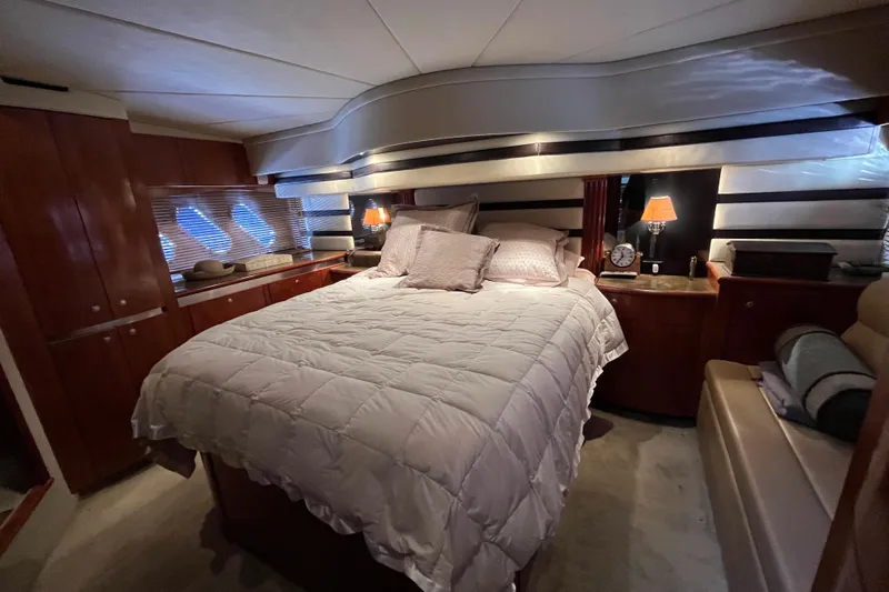 Dolcinea Yacht Photos Pics Luxurious bedroom interior of 2010 Cruisers Yachts 520 Sports Coupe with cozy bedding.