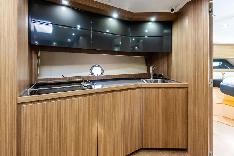Po-sea-tive Vibez Yacht Photos Pics Modern kitchen interior of 2013 Azimut Atlantis 48 yacht with wood cabinetry and sleek design.