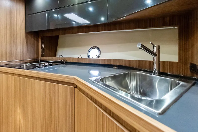 Po-sea-tive Vibez Yacht Photos Pics Modern kitchen in 2013 Azimut Atlantis 48 yacht with sleek wood cabinetry and stainless steel sink.