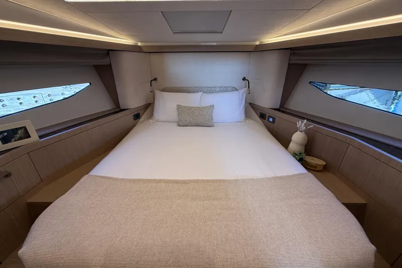  Yacht Photos Pics Luxurious cabin interior of 2026 Prestige F4.3 yacht with elegant bedding and modern design.