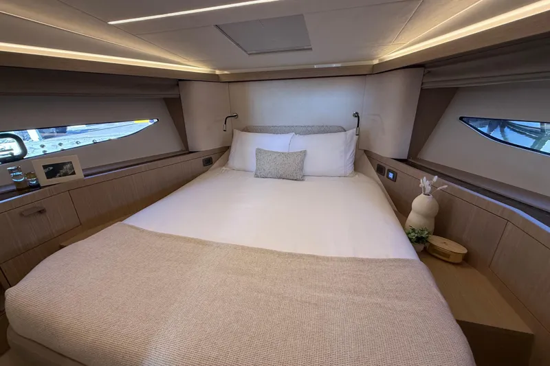  Yacht Photos Pics Luxurious bedroom interior of 2026 Prestige F4.3 yacht with elegant decor and ambient lighting.