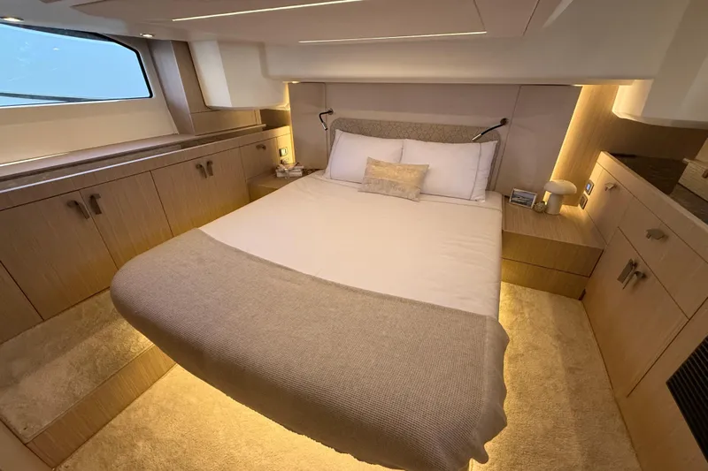  Yacht Photos Pics Luxurious cabin interior of 2026 Prestige F4.3 yacht with cozy bed and ambient lighting.