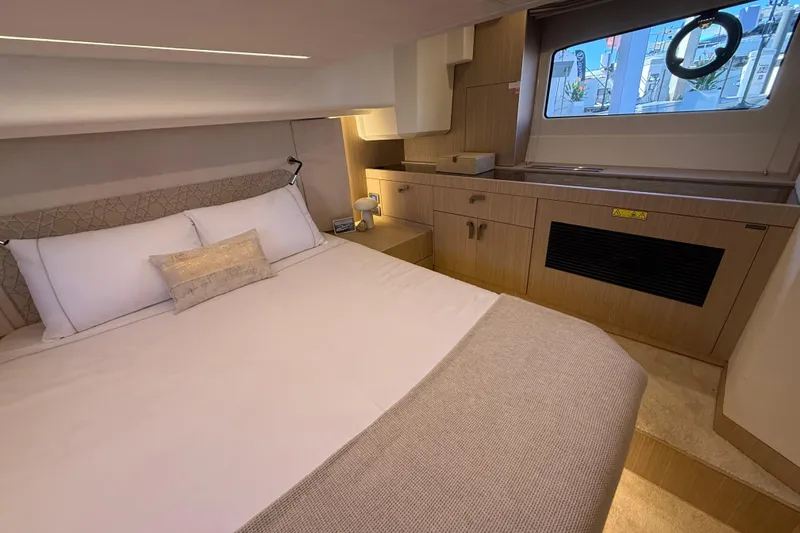  Yacht Photos Pics Luxurious cabin interior of 2026 Prestige F4.3 yacht with elegant bedding and modern design.