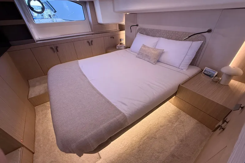  Yacht Photos Pics Luxurious bedroom interior of 2026 Prestige F4.3 yacht with modern design and ambient lighting.