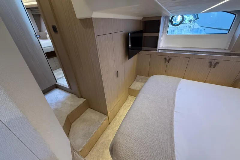  Yacht Photos Pics Luxurious cabin interior of 2026 Prestige F4.3 yacht with modern design and cozy bedding.