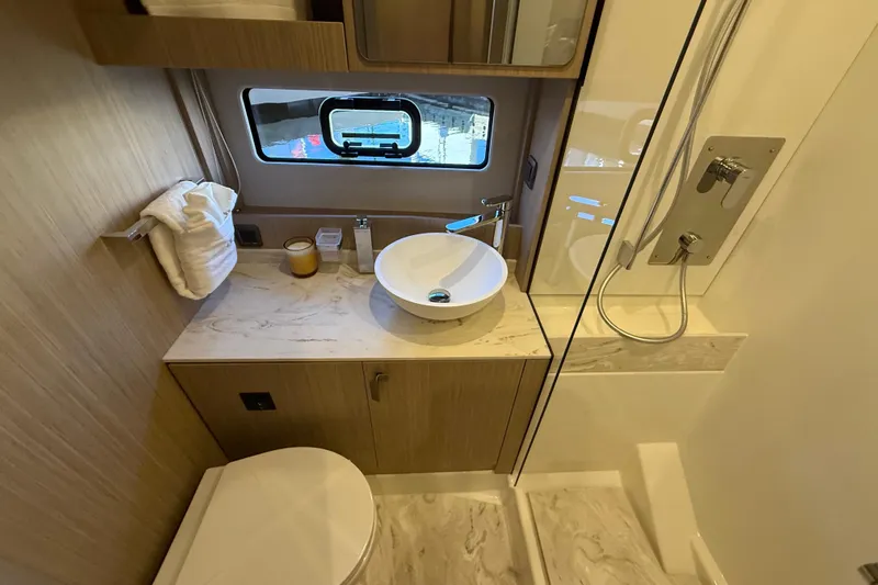  Yacht Photos Pics Luxurious 2026 Prestige F4.3 yacht bathroom with modern fixtures and elegant design.
