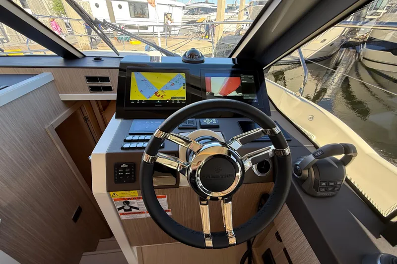  Yacht Photos Pics Steering console of 2026 Prestige F4.3 yacht with navigation display and controls.