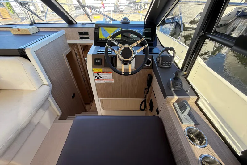  Yacht Photos Pics Interior cockpit of 2026 Prestige F4.3 yacht with modern steering and navigation controls.