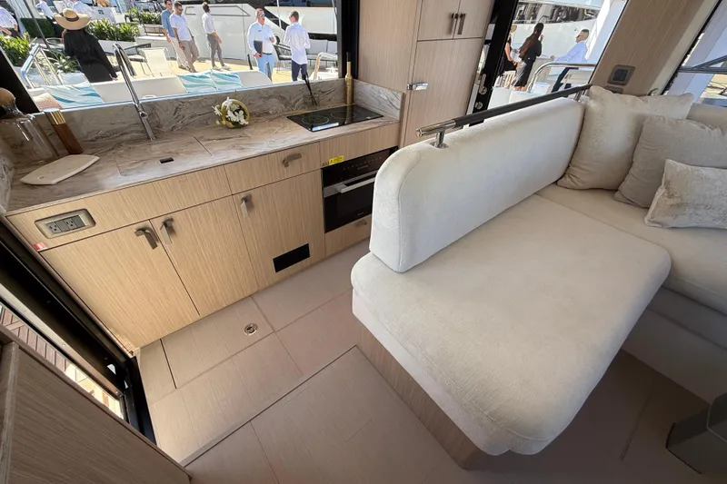  Yacht Photos Pics Luxurious interior of 2026 Prestige F4.3 yacht with modern kitchen and seating area.