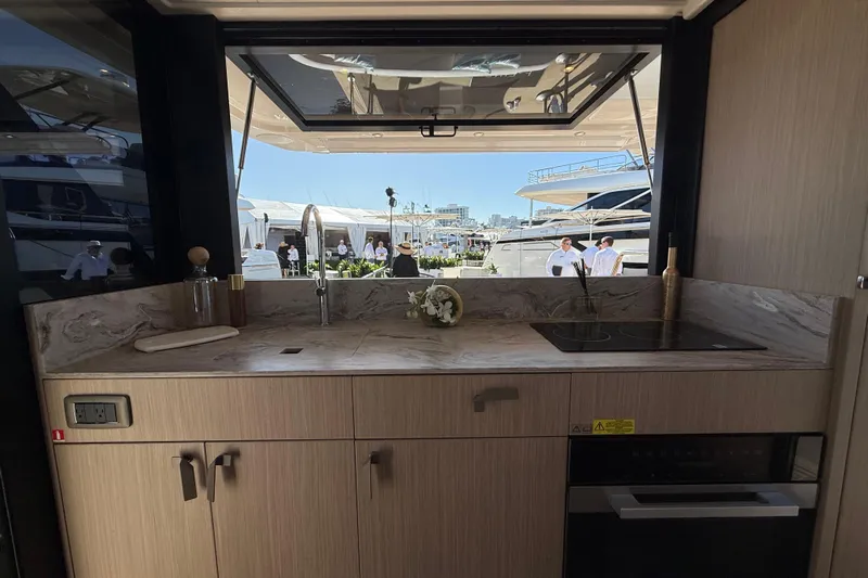  Yacht Photos Pics Luxurious 2026 Prestige F4.3 yacht kitchen with modern appliances and marina view.