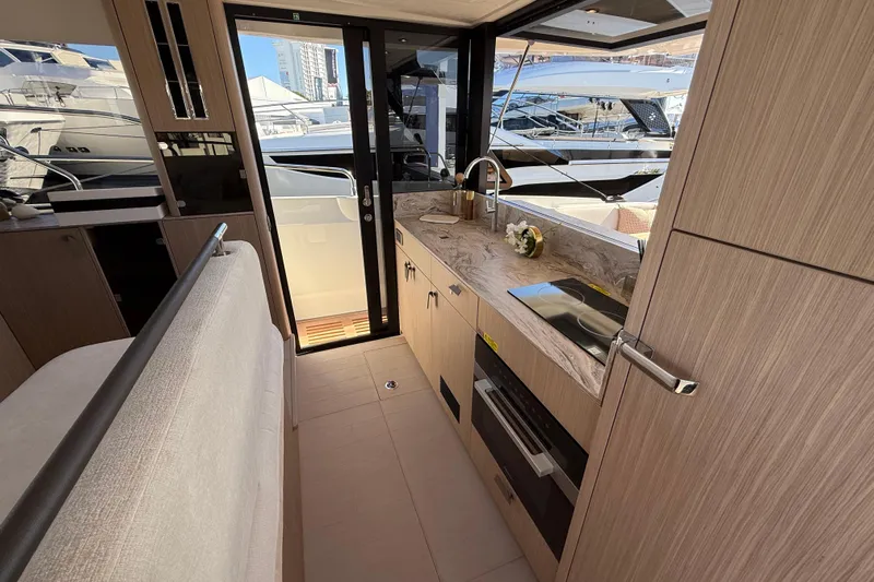  Yacht Photos Pics Modern kitchen interior of 2026 Prestige F4.3 yacht with sleek design and appliances.