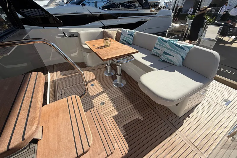  Yacht Photos Pics Luxurious 2026 Prestige F4.3 yacht deck with elegant seating and wooden flooring.