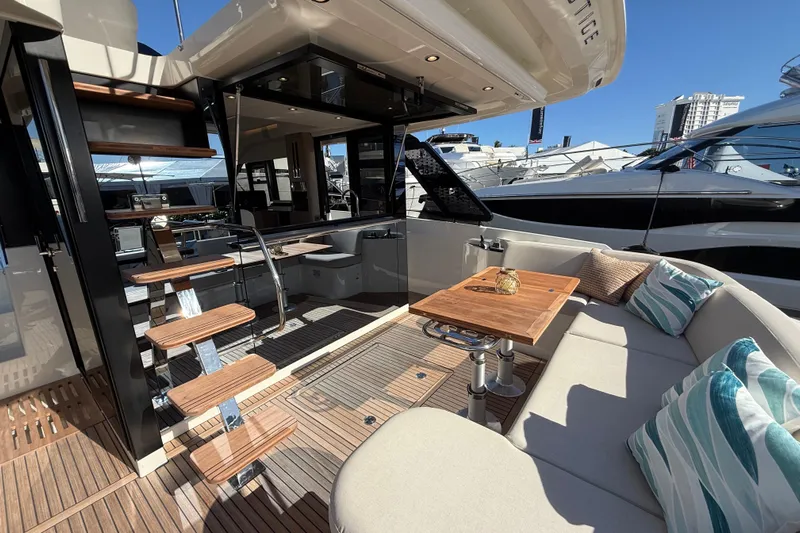  Yacht Photos Pics Luxurious 2026 Prestige F4.3 yacht interior with elegant seating and wooden accents.