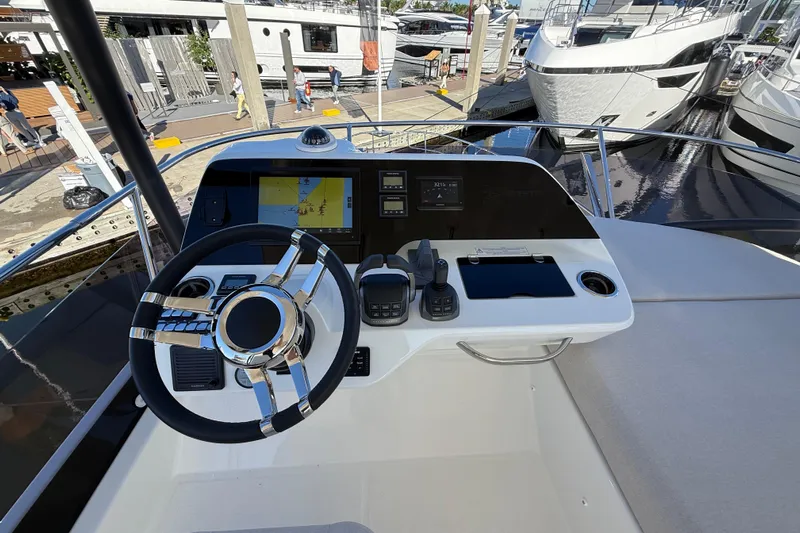  Yacht Photos Pics Helm of 2026 Prestige F4.3 yacht with modern navigation controls and steering wheel.