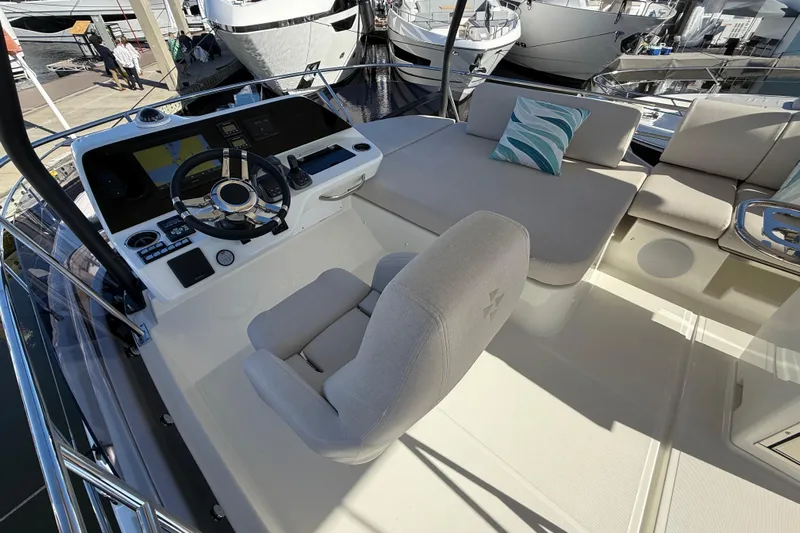  Yacht Photos Pics Luxurious 2026 Prestige F4.3 yacht helm with plush seating and modern controls.