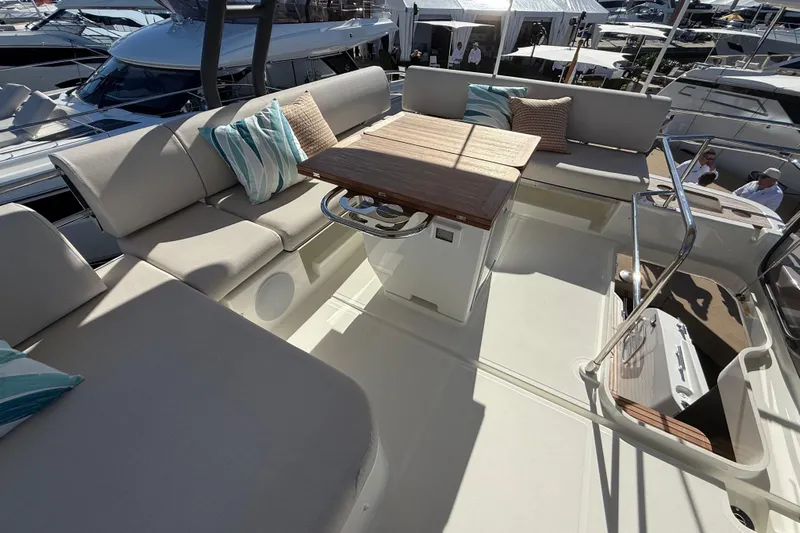  Yacht Photos Pics Luxurious seating area on 2026 Prestige F4.3 yacht with cushions and wooden table.