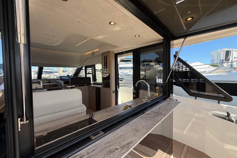  Yacht Photos Pics Luxurious interior of 2026 Prestige F4.3 yacht with modern kitchen and seating area.