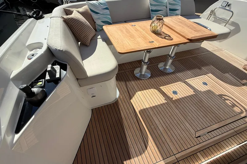  Yacht Photos Pics Luxurious 2026 Prestige F4.3 yacht deck with elegant seating and wooden table.