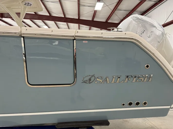  Yacht Photos Pics 2026 Sailfish 316 DC boat side view in a warehouse setting.