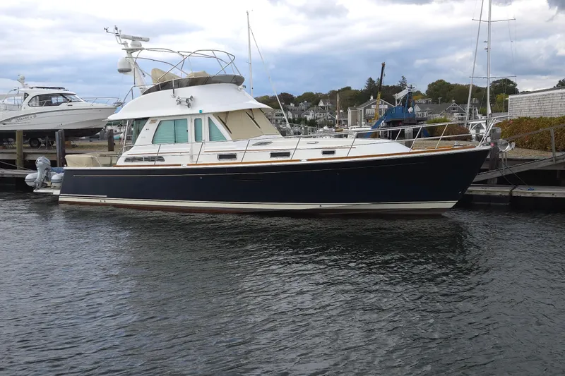 Grayson Yacht Photos Pics 2017 Sabre 48 Fly Bridge yacht docked at marina, side view.