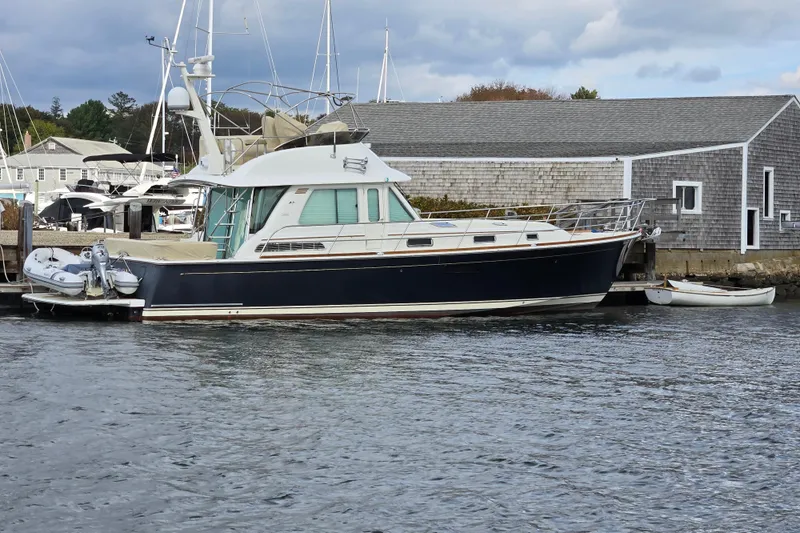 Grayson Yacht Photos Pics 2017 Sabre 48 Fly Bridge yacht docked at marina, calm water, overcast sky.